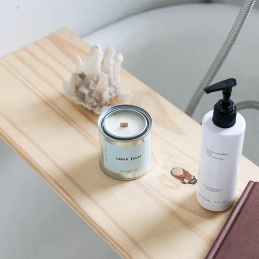 mala cabin fever candle on a bath tray